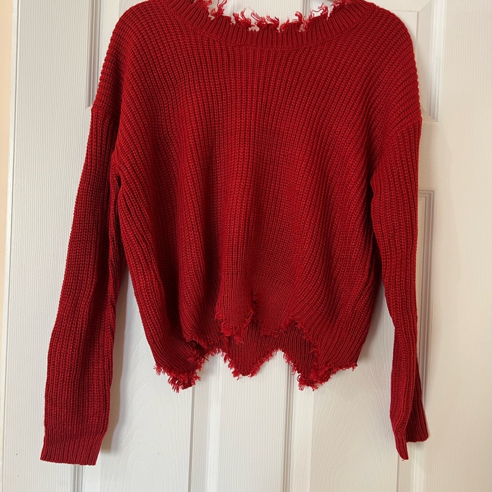 Red fringed knitted sweater.